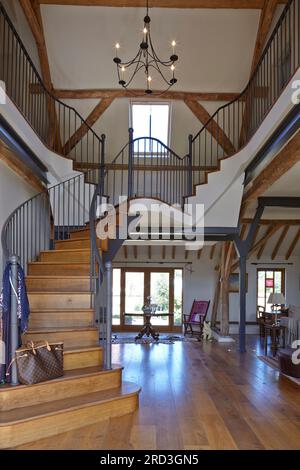 Barn conversion interior timer frame & beams. Wood floor and furniture ...