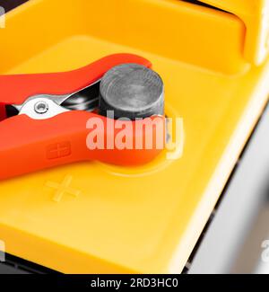 car battery with connected wires on charge close-up Stock Photo