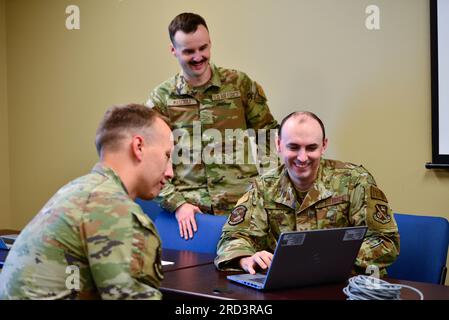 U.S. Air Force Staff Sgt. Kevin White and Airman 1st Class Andrey Mascioli, personnelists with the 134th Force Support Squadron, updates records as the mobile data team for Master Sgt. Matthew Finfrock, lodging manager, 134th FSS, June 27, 2023, Savannah, Georgia. Approximately 100 Tennessee Air Guardsmen with the 134th Mission Support Group and additional support personnel converged on the Combat Readiness Training Center, June 24 to 30 for the Air Force's revamped model of deployment readiness training, AFFROGEN. Stock Photo