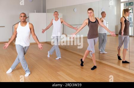 Young adults practicing dance movements in choreography class Stock Photo