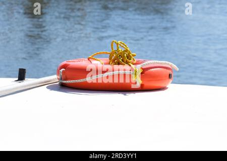 Lifebuoy safety rescue help saver on the boat. Selective focus included. Life saver nautical concept background. Stock Photo