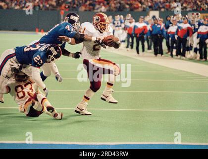 Atlanta Falcons linebacker Robert Lyles (54) pulls on the jersey of  Washington Redskins running back Earnest Byner (21) during first quarter  NFL Divisional playoff action, Jan. 4, 1992, at RFK Stadium in