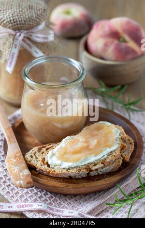 vineyard peach jam on the piece of bread and in a glass Stock Photo