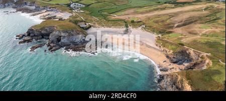 Aerial landscape panorama view of Church Cove with it's historic church and Dollar Cove at Gunwalloe in Cornwall at sunset Stock Photo
