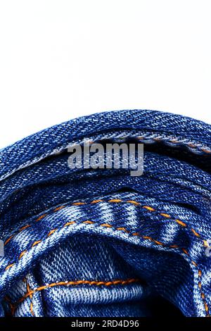 Rolled up blue denim jeans isolated on a white background with copy space Stock Photo