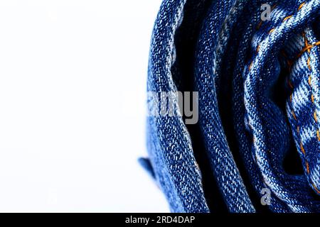 Rolled up blue denim jeans isolated on a white background with copy space Stock Photo