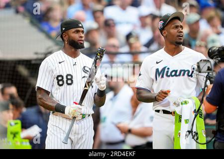 Miami Marlins' Jorge Soler holds up a chain necklace in the dugout