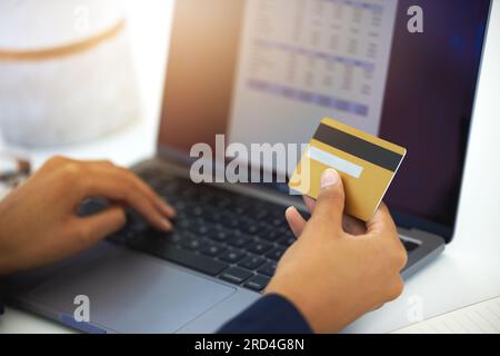 Credit card, laptop and business man hands for invoice, online payment and budget or digital receipt in accounting. Business person on computer screen Stock Photo