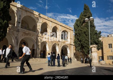 Horizontal view of some children playing in the playground of a Sephardic Educational Center in the Jewish Quarter, Jerusalem, Israel Stock Photo