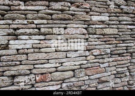 The wall is built of natural stone Stock Photo