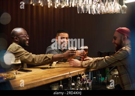 Premium Photo  Two intercultural guys in sunglasses and casualwear having  drinks in cafe