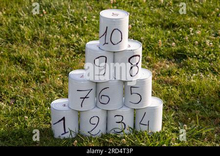 stacked tin can pyramid game for can knockdown games at funfair Stock Photo