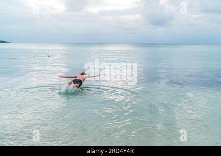 Diving teenage boy snorkeling underwater in the lagoon on Le Morne beach, Indian Ocean, Mauritius island. Exotic traveling and vacation concept Stock Photo