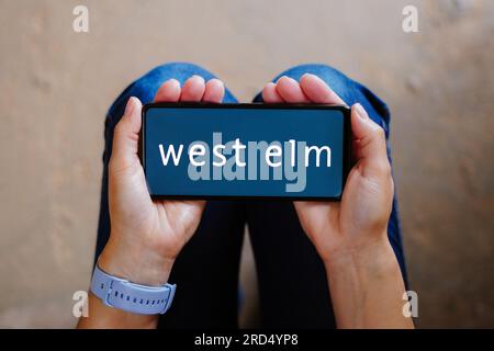 In this photo illustration, the West Elm logo seen displayed on a smartphone. Stock Photo