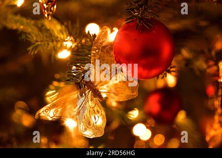 Christmas Decoration Butterfly with Christmas Tree Ball Hanging on Fir Tree Stock Photo