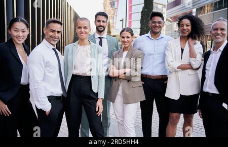 Team portrait multi-ethnic professionals smiling posing with confidence. Young and mature colleagues Stock Photo