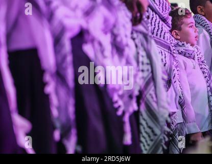 Gaza, Palestine. 18th July, 2023. A Palestinian boy sings in a closing ceremony for the children's choir entitled 'Enjoy your life with music' in Gaza City. A musical group from Al-Sununu Foundation for Culture organizes a closing ceremony for the children's choir entitled 'Enjoy your life with music' in partnership with the German Agency, in the presence of the Palestinian Minister of Women's Affairs Amal Hamad and the Director General of UNRWA Operations in Palestine Thomas White and dozens of Palestinians interested in music. Credit: SOPA Images Limited/Alamy Live News Stock Photo