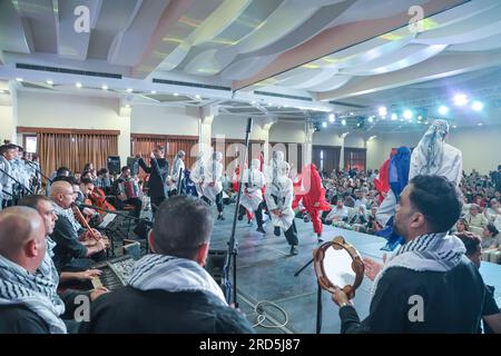 Gaza, Palestine. 18th July, 2023. Palestinian children participate in a closing ceremony for the children's choir entitled 'Enjoy your life with music' in Gaza city. A musical group from Al-Sununu Foundation for Culture organizes a closing ceremony for the children's choir entitled 'Enjoy your life with music' in partnership with the German Agency, in the presence of the Palestinian Minister of Women's Affairs Amal Hamad and the Director General of UNRWA Operations in Palestine Thomas White and dozens of Palestinians interested in music. Credit: SOPA Images Limited/Alamy Live News Stock Photo