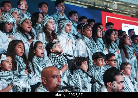 Gaza, Palestine. 18th July, 2023. Palestinian children participate in a closing ceremony for the children's choir entitled 'Enjoy your life with music' in Gaza city. A musical group from Al-Sununu Foundation for Culture organizes a closing ceremony for the children's choir entitled 'Enjoy your life with music' in partnership with the German Agency, in the presence of the Palestinian Minister of Women's Affairs Amal Hamad and the Director General of UNRWA Operations in Palestine Thomas White and dozens of Palestinians interested in music. Credit: SOPA Images Limited/Alamy Live News Stock Photo