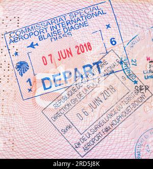 Senegal exit stamp in an open passport with point of departure Aéroport de Dakar, Blaise Diagne International Airport. Senegal exit stamp. Stock Photo