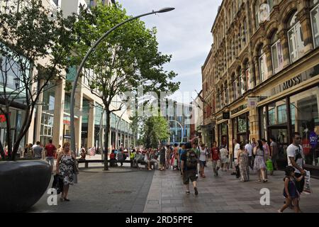 Shoppers walking on the Hayes in Cardiff city centre Wales UK. Pedestrian area shopping shops, St Davids 2 building Busy British city street Stock Photo