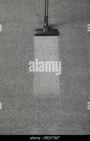 Vacuuming grey carpet. Clean area after using device, top view. Space for text Stock Photo