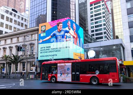 Auckland, New Jersey, New Zealand. 19th July, 2023. A bus rides past a Jumbotron displaying (left) Italy forward CRISTIANA GIRELLI, (center), New Zealand midfielder GRACE JALE and (right) United States forward MEGAN RAPINOE in preparation for the start of the 2023 FIFA Women's World Cup on Queens Street, Auckland, New Zealand (Credit Image: © Ira L. Black/ZUMA Press Wire) EDITORIAL USAGE ONLY! Not for Commercial USAGE! Stock Photo