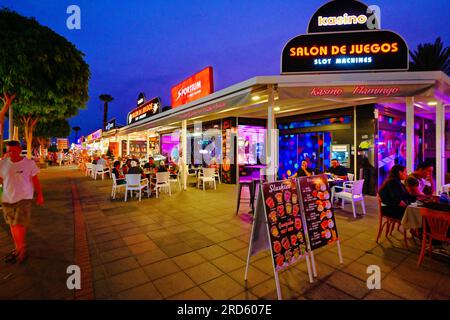 Lanzarote Canary Islands bars shops and restaurants on the Ave  Las Playas with clear dark blue evening sky Stock Photo