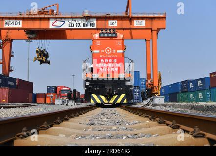 Zhengzhou, July 18. 18th July, 2013. A China-Europe freight train bound for Hamburg, Germany waits for departure at Putian Station in Zhengzhou, capital of central China's Henan Province, July 18, 2023. Zhengzhou has handled 7,572 China-Europe freight trains which have carried 670,000 twenty-foot equivalent units (TEUs) of cargo since July 18, 2013. Credit: Li Jianan/Xinhua/Alamy Live News Stock Photo