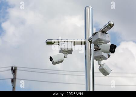 Surveillance cameras mounted on stainless steel poles. for safety and to record various observations in the nearby area Stock Photo