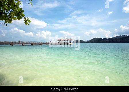Jetty at Pulau Beras Basah, Langkawi, Malaysia. - The beautiful scenery of long Jetty with clear blue sky and water, Pulau Beras Basah Island, Langkaw Stock Photo