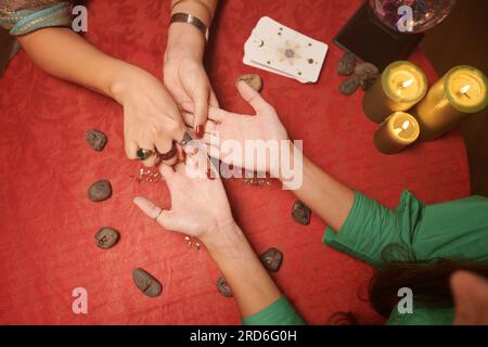 Gypsy reading palm lines to interpret personality characteristics and predict future happenings Stock Photo