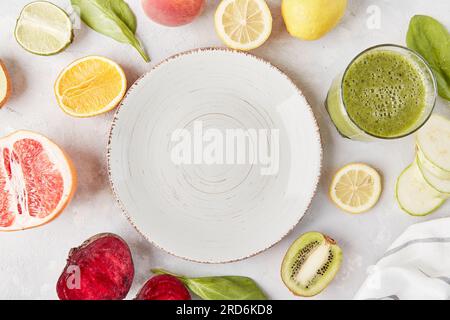 White plate in the center among vegetables, fruits and smoothie close up .Vegan food, Keto, FODMAP, Paleo, Low-carb, plant-based diet, top view, copy space. Stock Photo