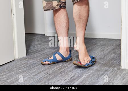 Man with barefoot shoes standing on floor Stock Photo
