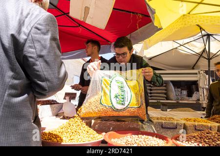 Young man selling yello corn in street market Ürgüp/Nevşehir Cappadocia Turkey Stock Photo