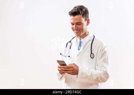 Image of young doctor using phone. Stock Photo