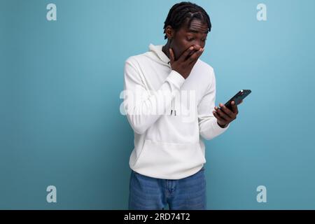 surprised man young african brunette with phone Stock Photo