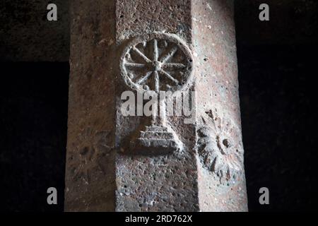 Bedsa- Buddhist symbols on one of the pillar on the right close to the stupa. Maharashtra, India Stock Photo
