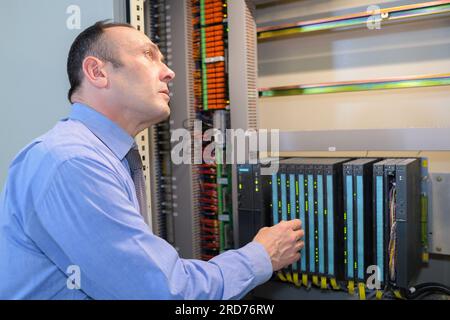 a computer technician connecting cables Stock Photo