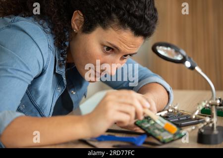 engineer woman repairs a laptop Stock Photo