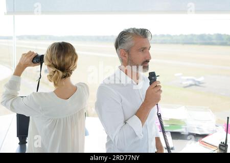 female and male control tower worker Stock Photo