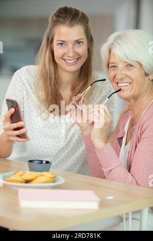 charming blogger shooting selfie with mom Stock Photo - Alamy