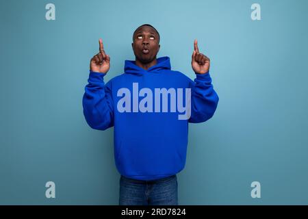 a handsome short-haired brunette African in a basic hoodie demonstrates the mind and resourcefulness of an idea Stock Photo