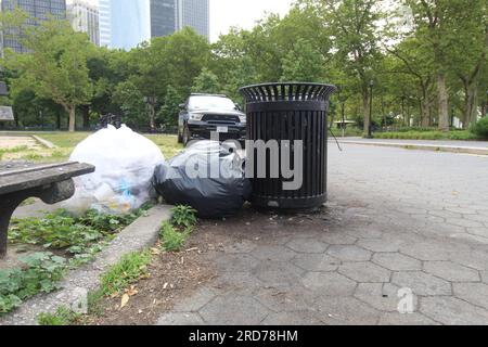A photo of a bin with two trash bags beside it in New York City. Stock Photo