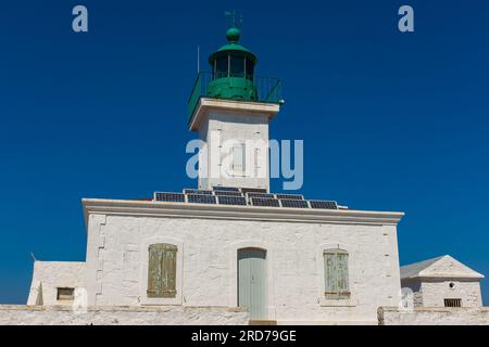 Ile Rousse, Corsica, 2020. Silhouetted against an intense blue sky, low angle shot of the lighthouse on l'Ile de la Pietra in the summer Stock Photo