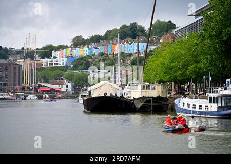Bristol floating harbour in rain with boats looking up to colourful houses in Clifton Wood, UK Stock Photo