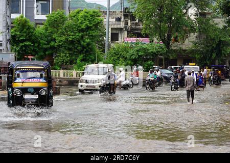 Ajmer, India. 18th July, 2023. Indian People Along A Flooded Road After 