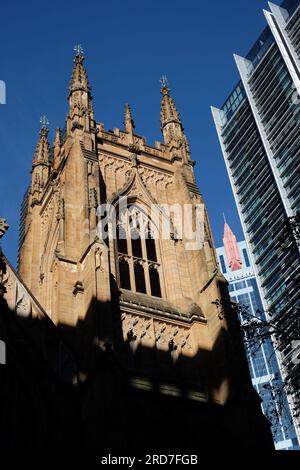 St. Andrew's Cathedral, a Gothic Revival architecture church in Sydney Sandstone from the 1800s with stained-glass windows, West Bell Tower detail Stock Photo