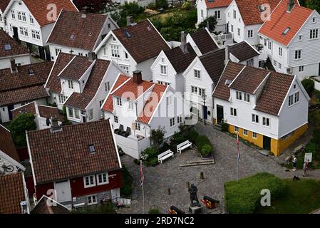 White painted houses in the Gamle area of Stavanger, Norway, including the statue of Vice Admiral Thore Horve. Stock Photo