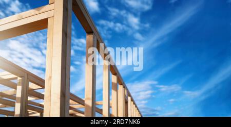 wooden house frame against blue sky background. banner with copy space Stock Photo